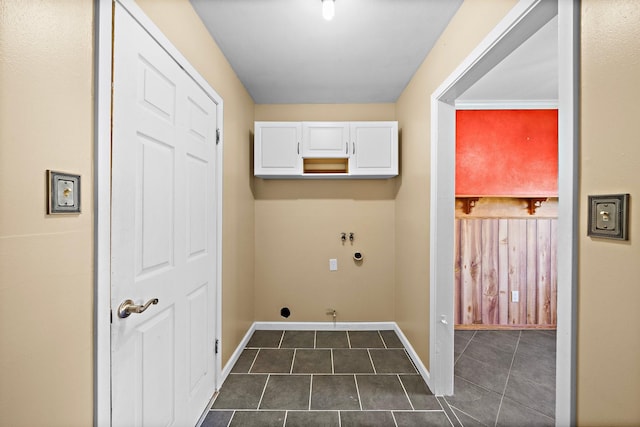 washroom with hookup for a gas dryer, dark tile patterned floors, cabinets, and washer hookup