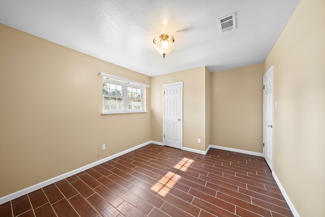 unfurnished bedroom featuring a closet and dark wood-type flooring