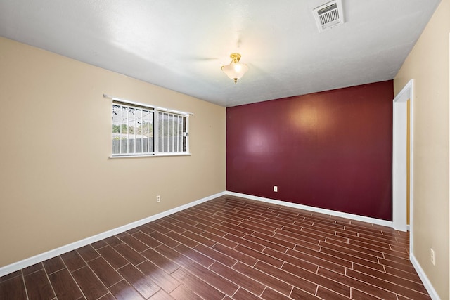 spare room with dark wood-type flooring