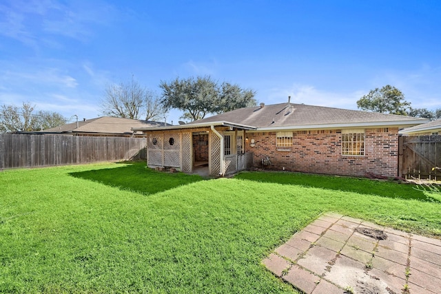 back of property with a patio area and a lawn