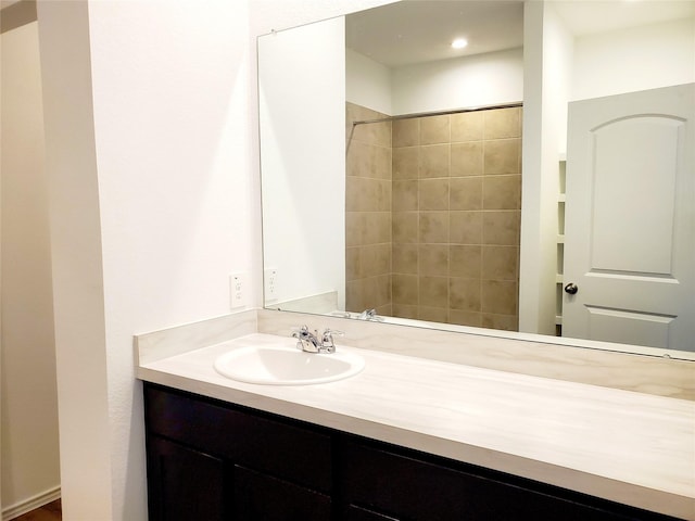 bathroom featuring vanity and a tile shower