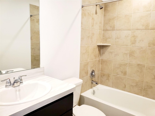 full bathroom with vanity, toilet, and tiled shower / bath