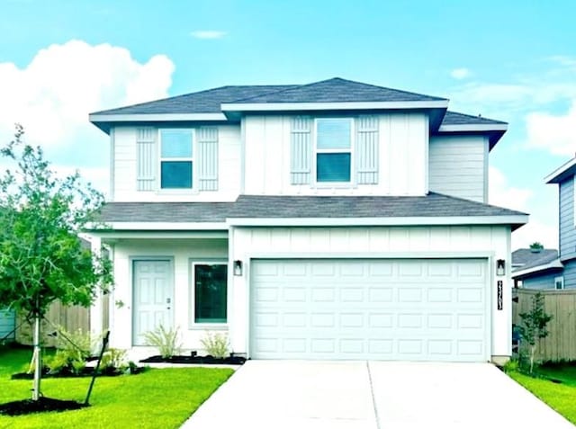 front facade with a front yard and a garage