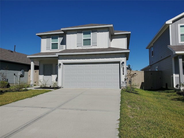 view of front of house featuring a front lawn and a garage