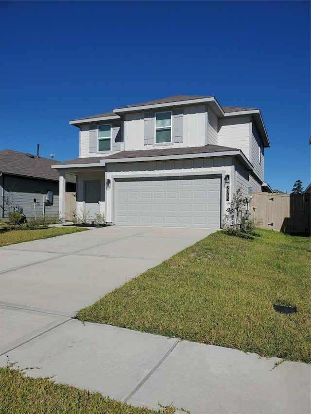 view of front of property featuring a garage and a front lawn