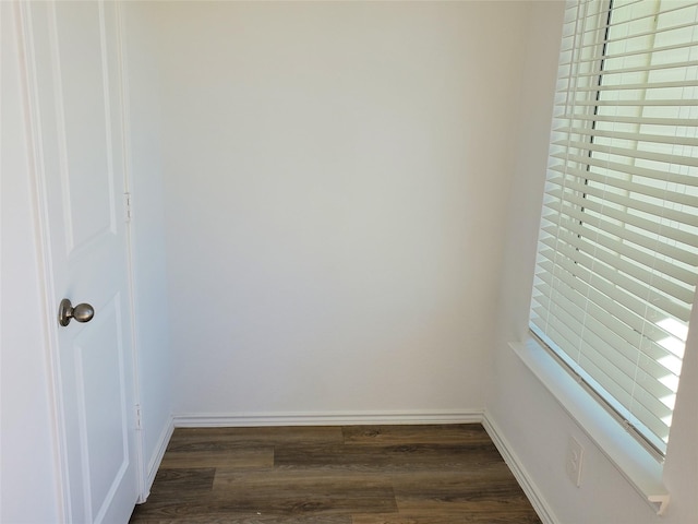 empty room with dark hardwood / wood-style flooring