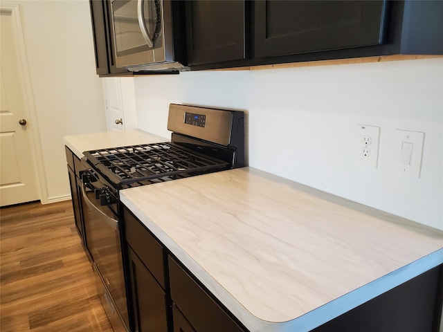 kitchen with hardwood / wood-style floors and stainless steel appliances