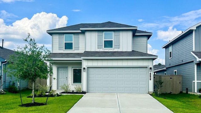 front of property with a garage and a front lawn