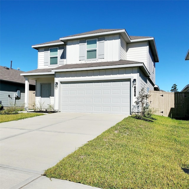 view of front of property featuring a garage and a front lawn