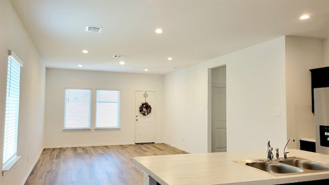 kitchen with sink and light hardwood / wood-style flooring