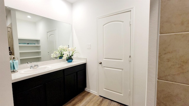 bathroom featuring hardwood / wood-style flooring and vanity