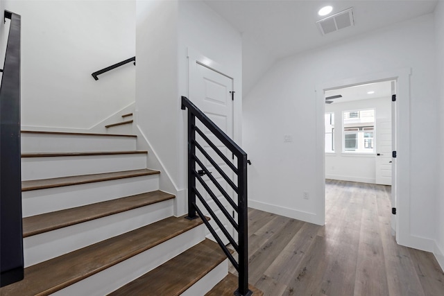 stairway with hardwood / wood-style floors