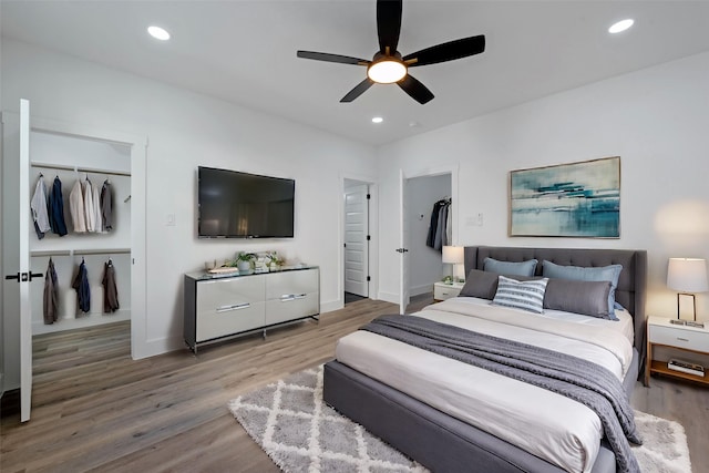 bedroom with hardwood / wood-style floors and ceiling fan