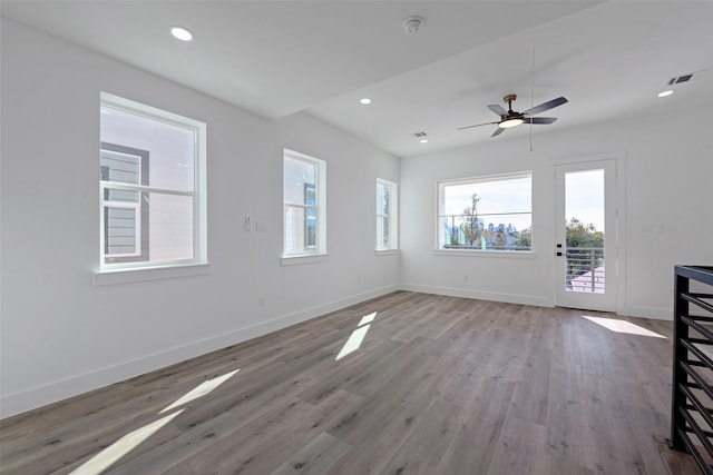 unfurnished living room with ceiling fan and hardwood / wood-style flooring