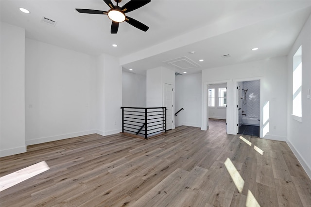 unfurnished living room with light wood-type flooring and ceiling fan