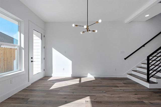 foyer featuring a wealth of natural light, dark hardwood / wood-style flooring, and a notable chandelier