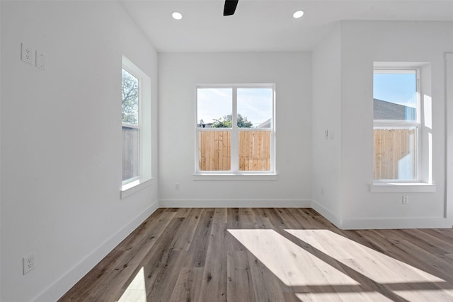 spare room with light hardwood / wood-style flooring, plenty of natural light, and ceiling fan