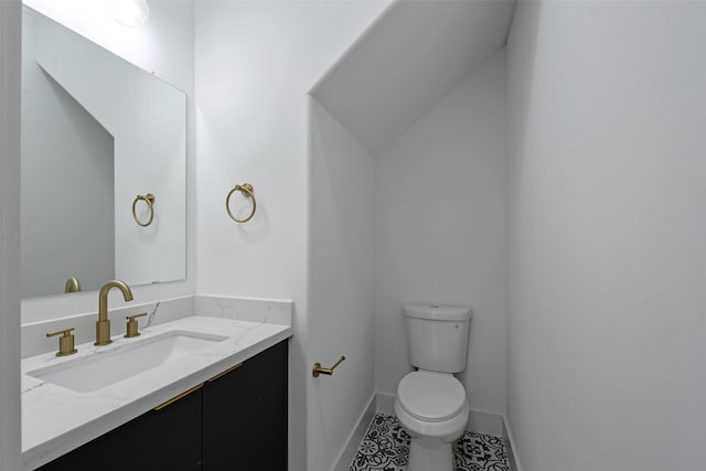 bathroom with tile patterned floors, vanity, and toilet