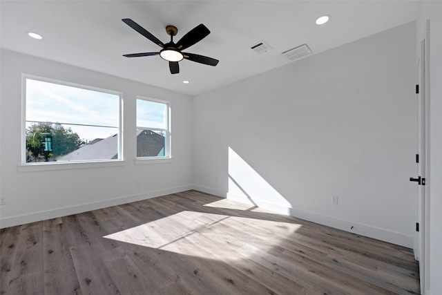 spare room with ceiling fan and hardwood / wood-style flooring