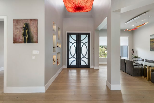 entryway featuring light wood-type flooring and french doors