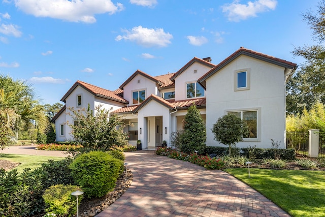 mediterranean / spanish house featuring a front yard