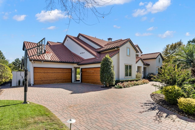 mediterranean / spanish home featuring a garage