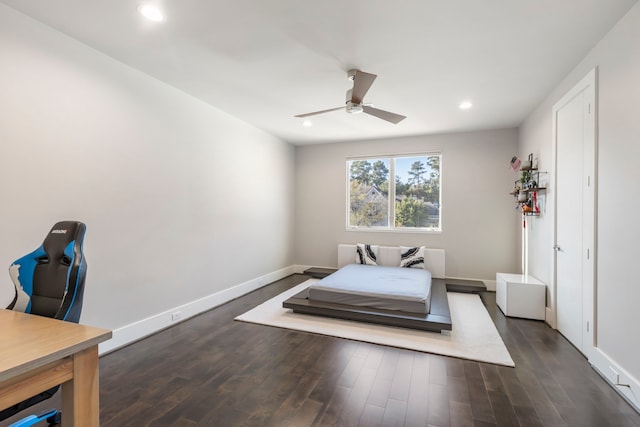 bedroom with ceiling fan and dark hardwood / wood-style floors