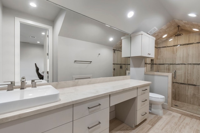 bathroom featuring vanity, an enclosed shower, and toilet