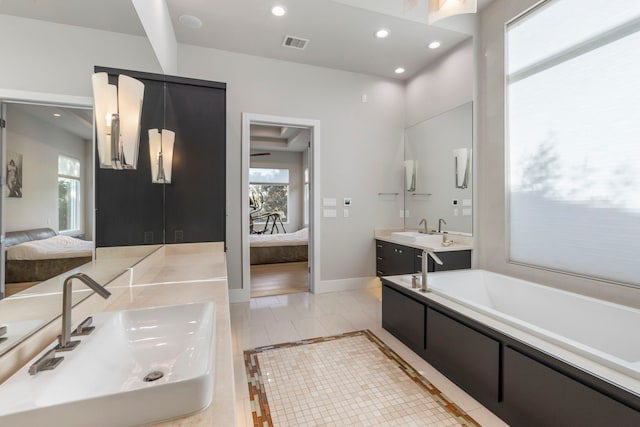 bathroom with a wealth of natural light, vanity, and wood-type flooring