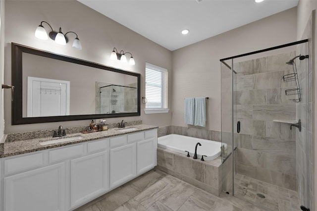 bathroom with separate shower and tub and vanity