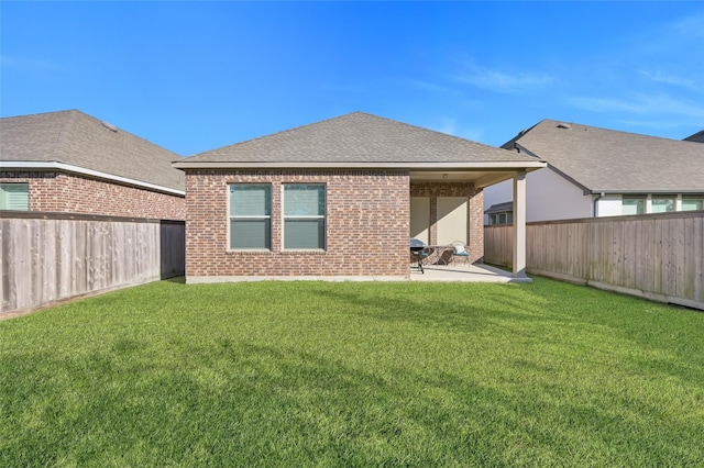 rear view of property featuring a yard and a patio