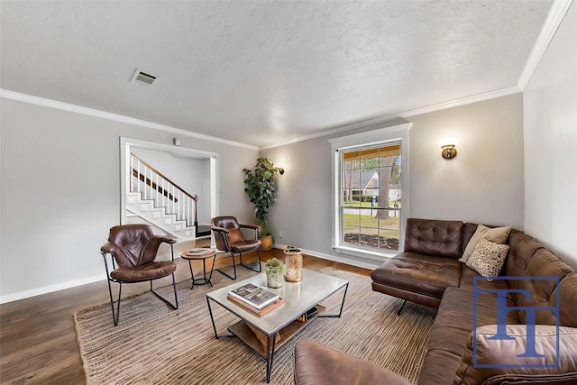 living room with wood-type flooring, a textured ceiling, and ornamental molding