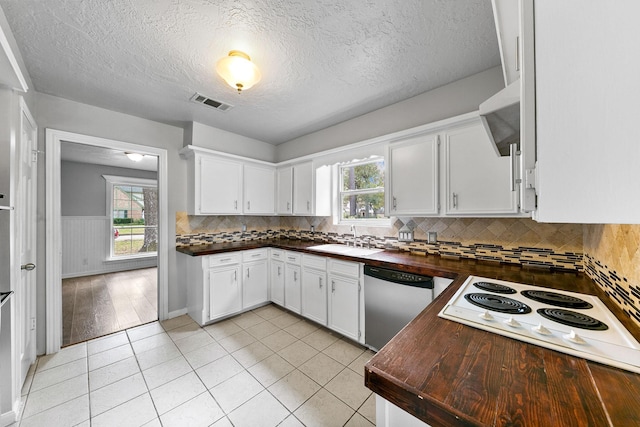 kitchen with stainless steel dishwasher, backsplash, white cabinetry, and sink