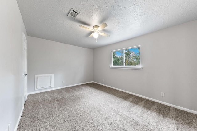 empty room featuring carpet flooring, a textured ceiling, and ceiling fan