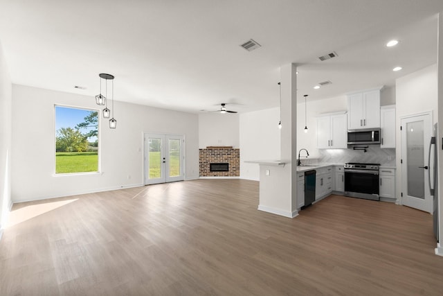 kitchen featuring dark hardwood / wood-style floors, white cabinetry, sink, and appliances with stainless steel finishes