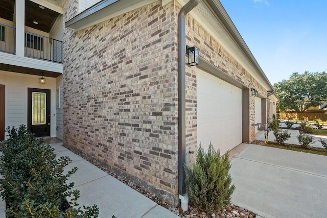 view of property exterior featuring a balcony and a garage