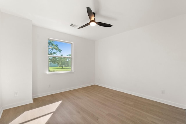 empty room featuring hardwood / wood-style floors and ceiling fan