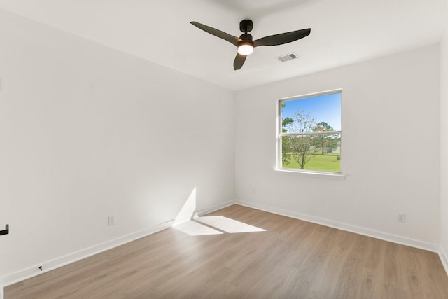 empty room featuring ceiling fan and light hardwood / wood-style flooring