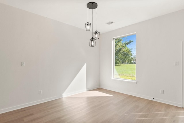 unfurnished dining area featuring light wood-type flooring