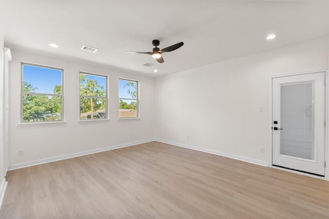 spare room featuring light hardwood / wood-style flooring and ceiling fan