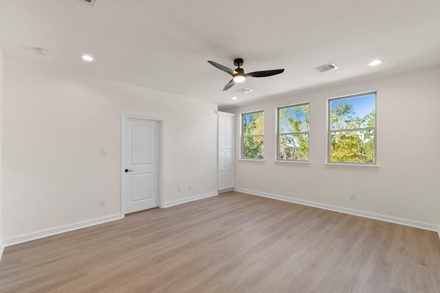 spare room with light hardwood / wood-style floors and ceiling fan