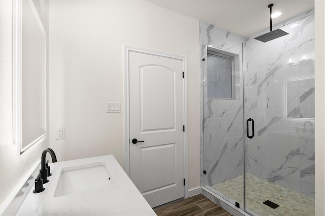 bathroom with hardwood / wood-style floors, vanity, and an enclosed shower