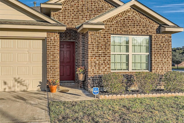 view of exterior entry featuring a garage