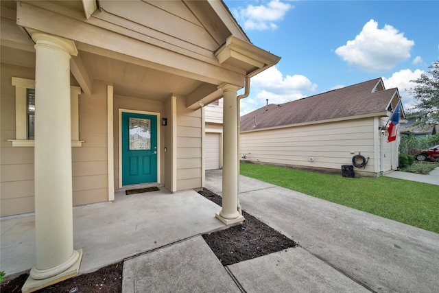 doorway to property with a lawn and a garage