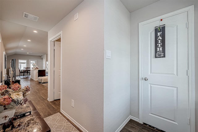 corridor featuring dark hardwood / wood-style floors and lofted ceiling