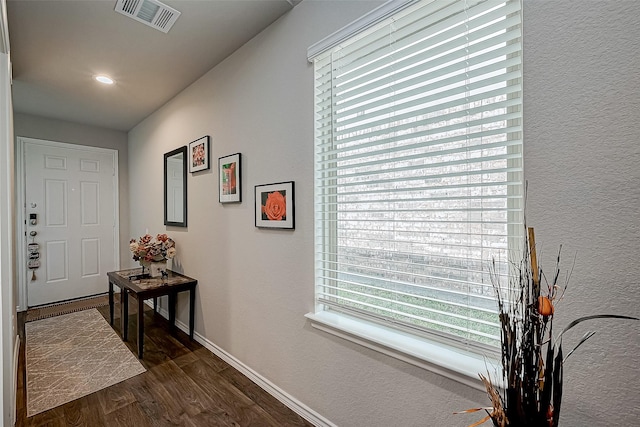 corridor with dark hardwood / wood-style flooring