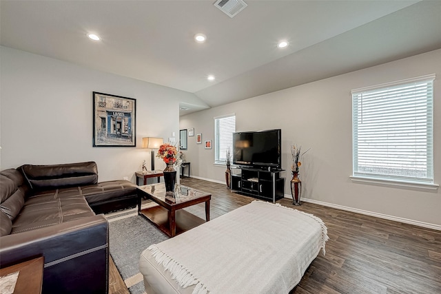 living room featuring dark hardwood / wood-style flooring and vaulted ceiling