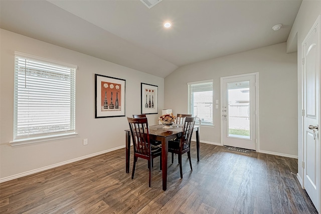 dining area with dark hardwood / wood-style flooring and vaulted ceiling