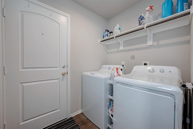 washroom with separate washer and dryer and dark hardwood / wood-style flooring