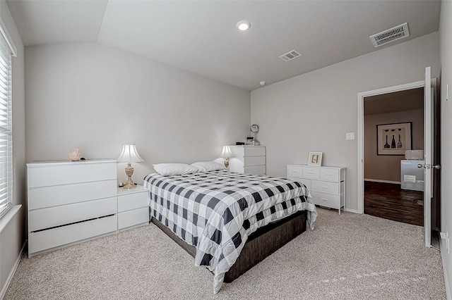 carpeted bedroom featuring lofted ceiling